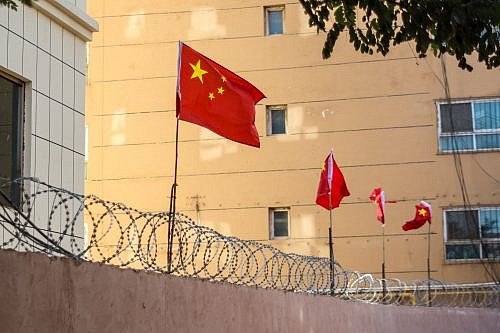 Chinese,Flags,On,Barbed,Wire,Wall,In,Kashgar,(kashi),,Xinjiang,